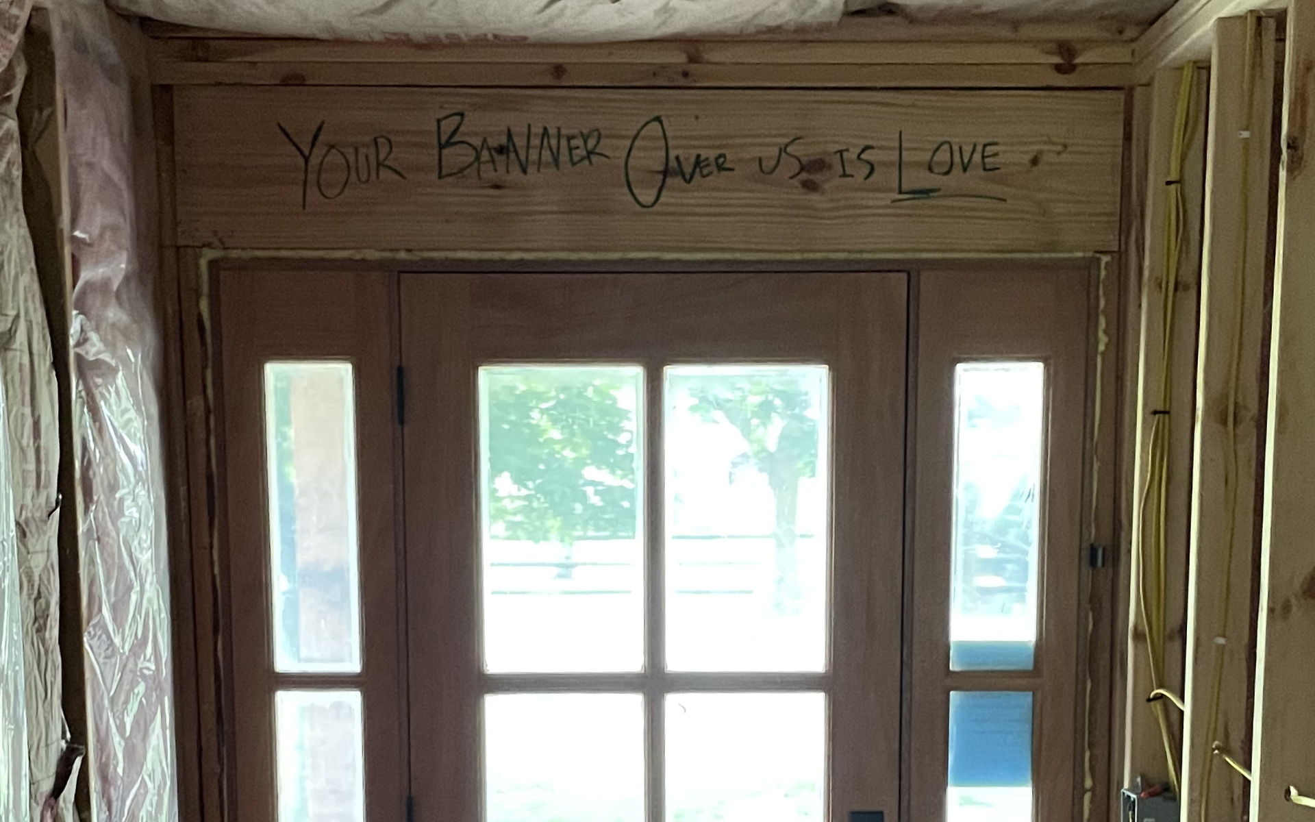 banner_love The header above the front door with the words YOUR BANNER OVER US IS LOVE written in sharpie marker